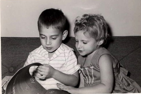 Black and white photo of kids Eric and Linda reading a picture book together